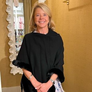 Black Etcetera poncho with faux fur trim.